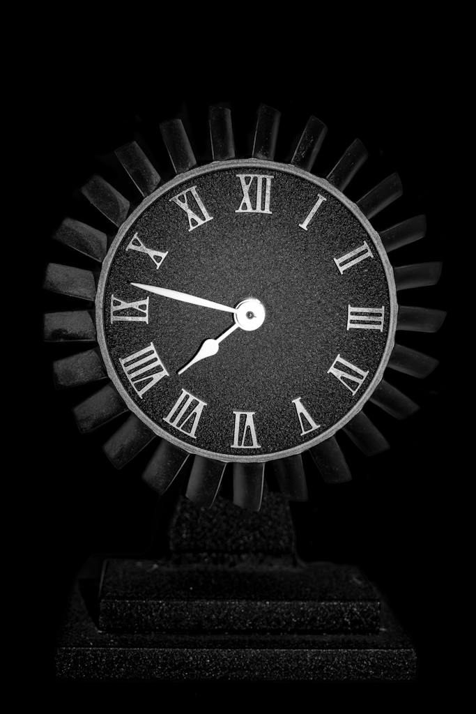 Round Black Wooden Analog Table Clock on Black Surface